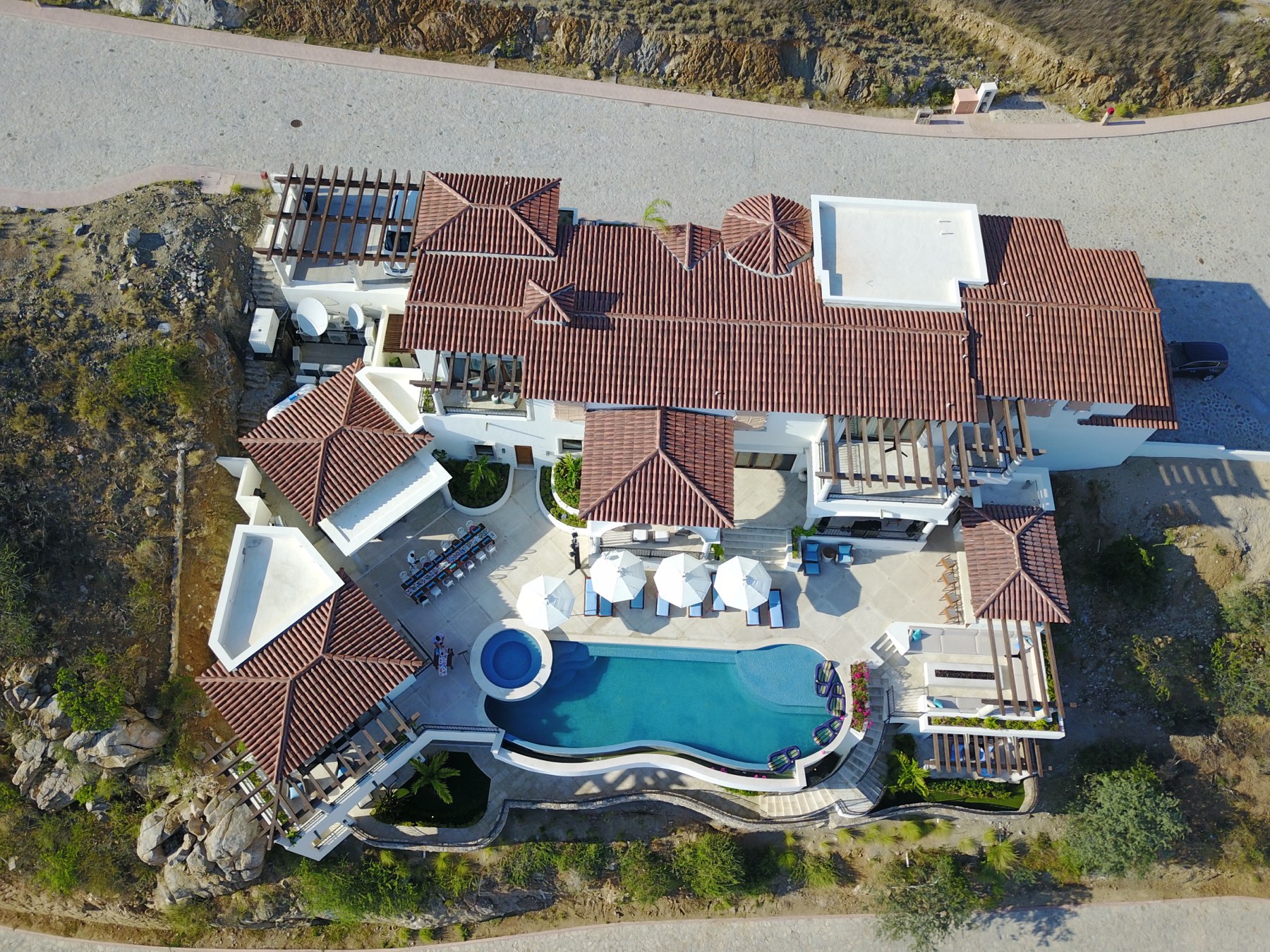 Casa Stella straight down from above — the tile roofs, terraces and infinity pool