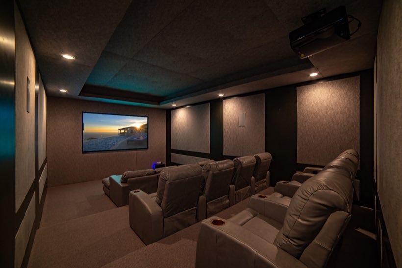 The movie theatre on the main level with power-controlled leather recliners