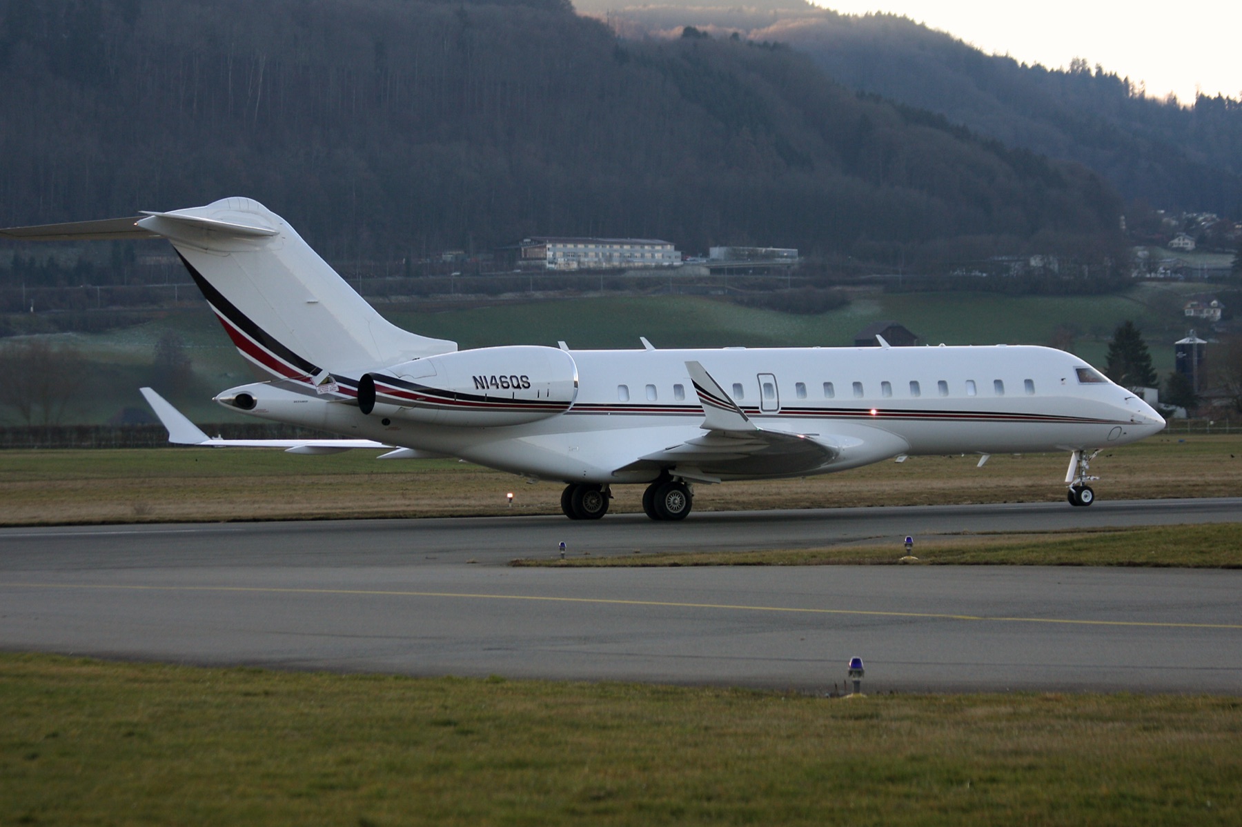 A Bombardier Global 6000 on the runway at dusk